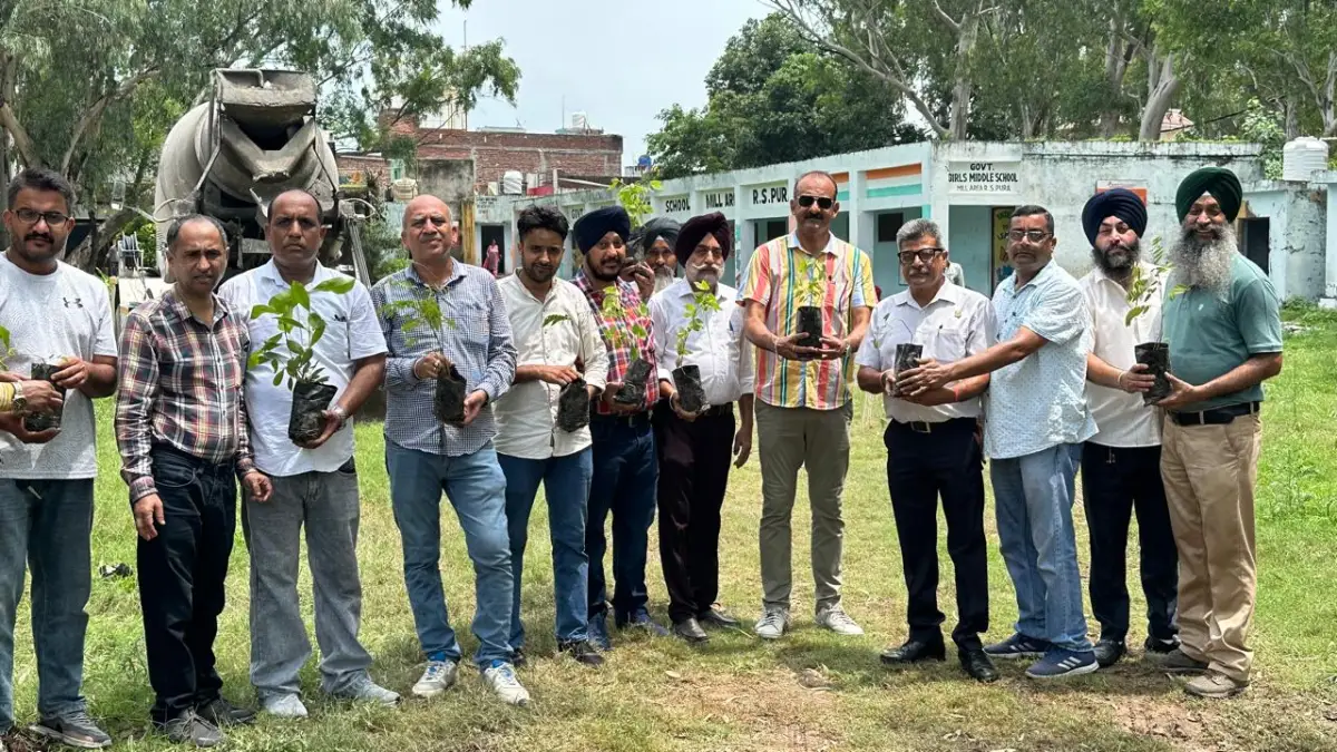 Sub-Divisional Agriculture Office staff holding saplings at Government Girls Middle School, R.S. Pura